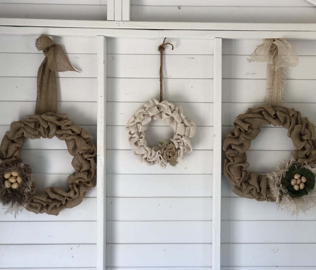 DIY Burlap Bubble Wreaths hanging.  Burlap bubble wreath DIY in brown with a nest.  DIY burlap bubble wreath white with a brown flower.  DIY burlap bubble wreath in brown with a nest with eggs.