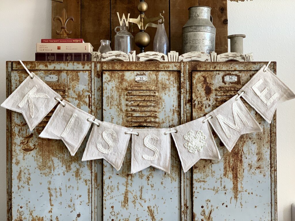 Easy DIY Bunting banner that says Kiss Me and has a clover for a St. Patrick's Day Bunting idea.