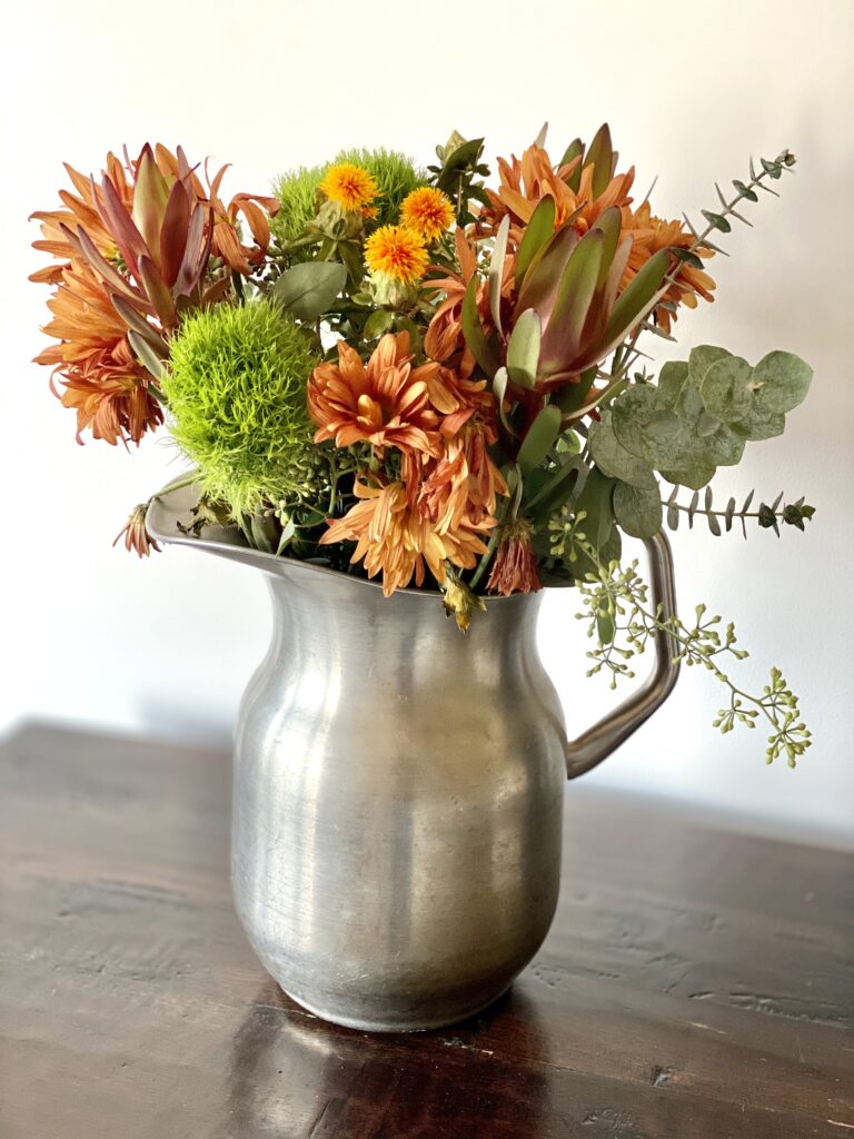 Fall flower arrangement in pitcher