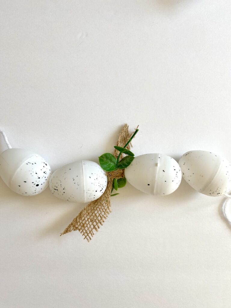 DIY Plastic Easter Egg Garland with white speckled eggs
