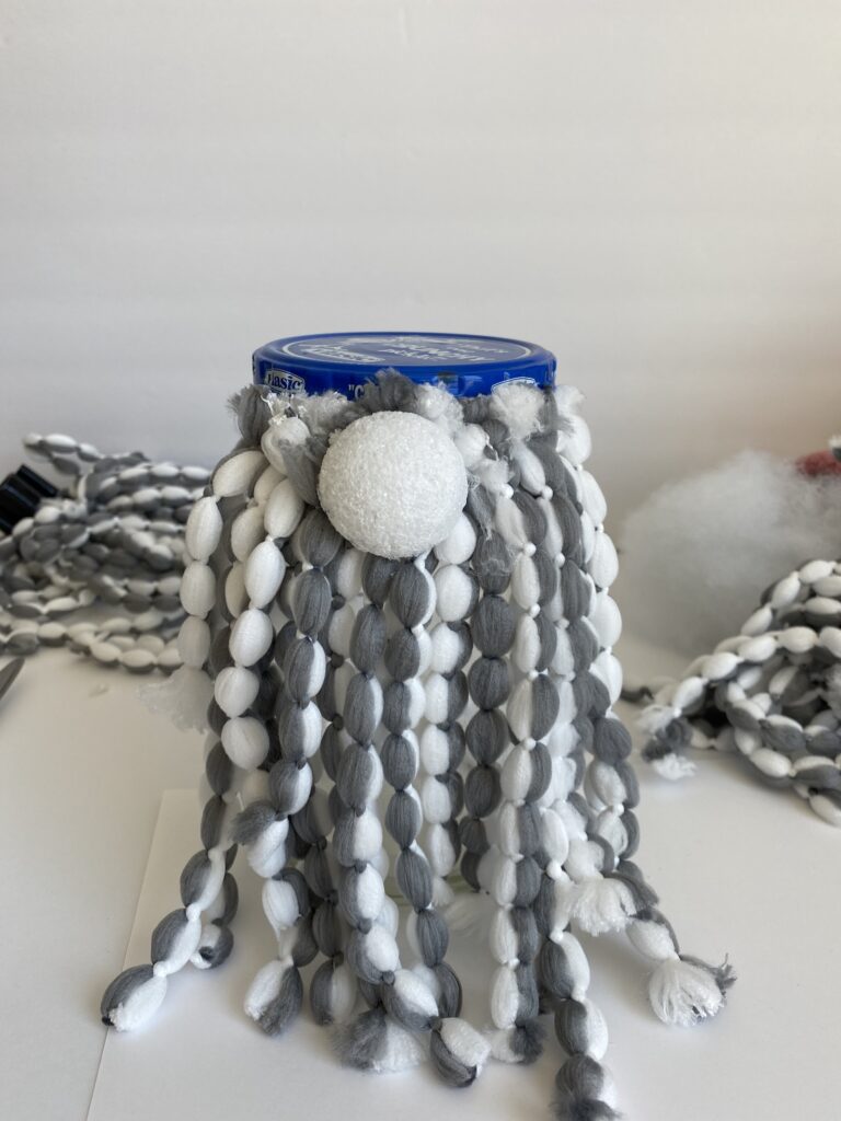 making a gray and white mop head gnome