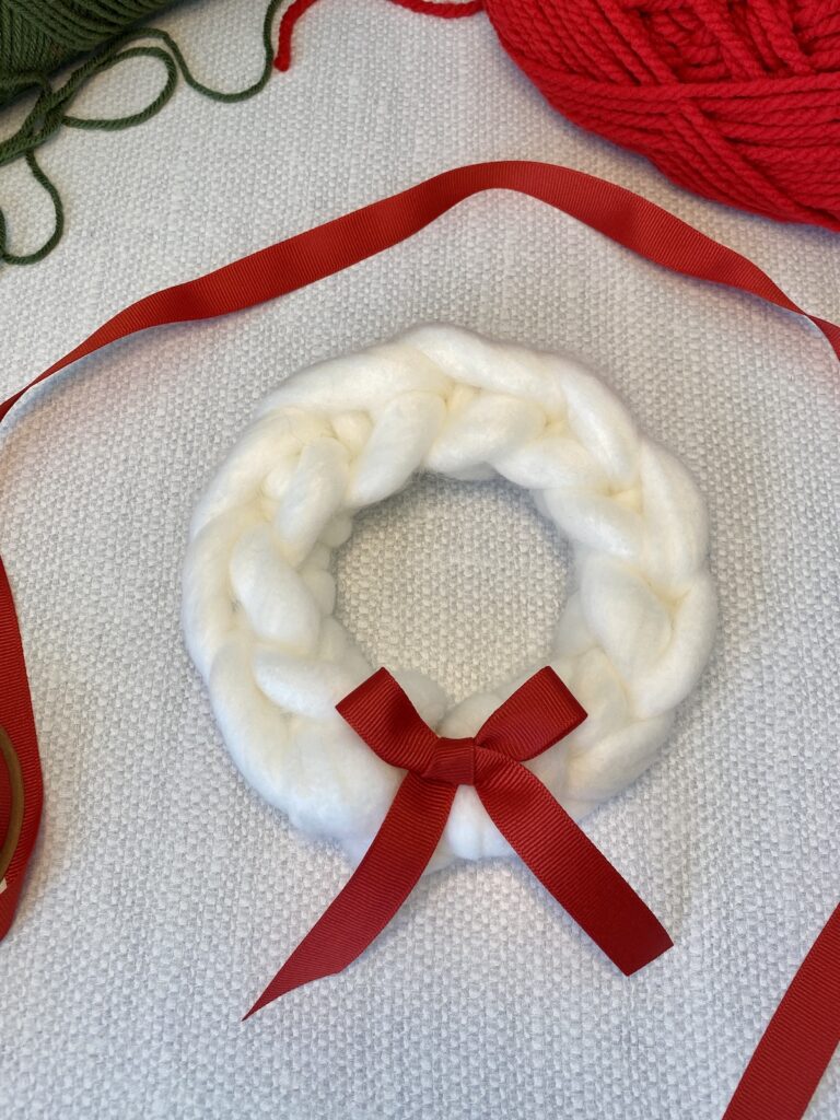 DIY yarn ornament wreath with a red bow