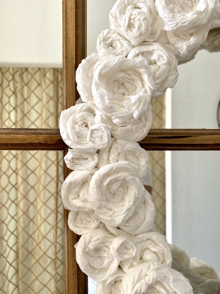 a close up of a wreath made with coffee filter roses (flowers)