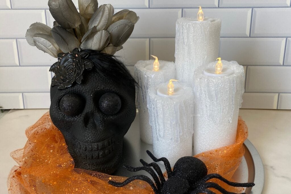 Pool Noodle Halloween Candles DIY with a skull and spiders