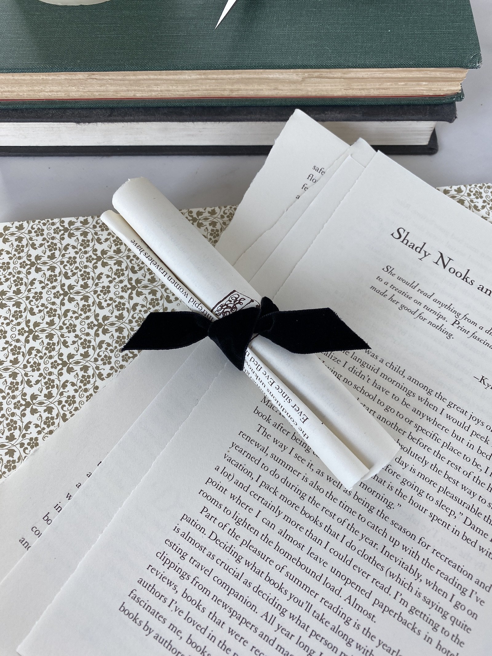 Rolled book page scroll with black velvet ribbon