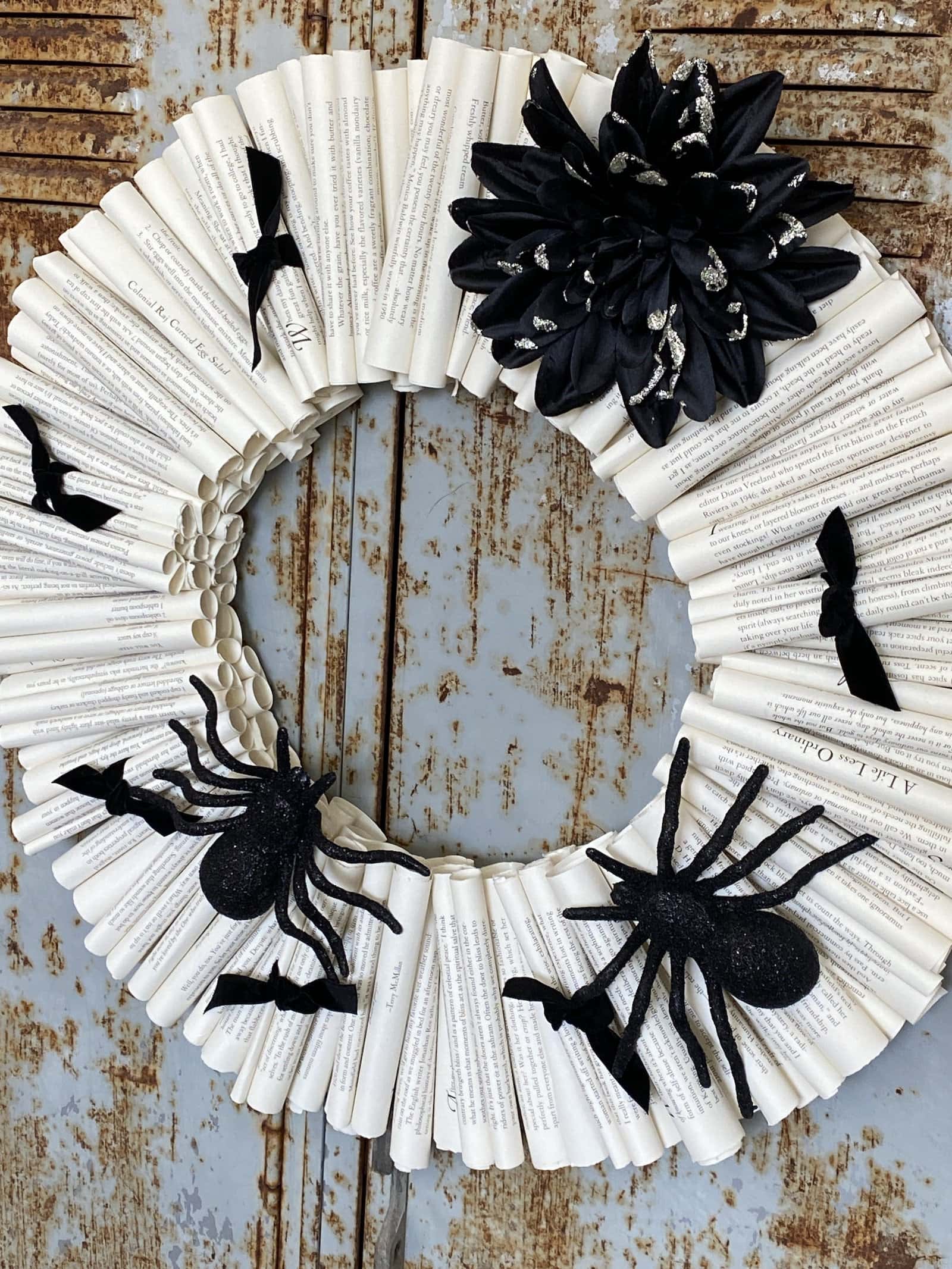 DIY Halloween Book Page Wreath with spiders and a black flower